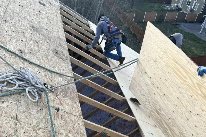 emergency roof repair in Renton WA crew stabilizing storm damage; homeowner checking roof damage safely in Renton
